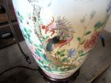a large vase with a bird and flowers on it