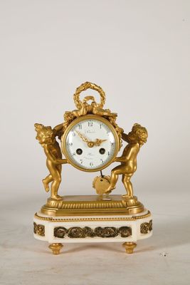 a gold clock with two cherensils on it