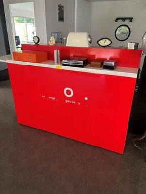 a red counter with a clock on it in a room