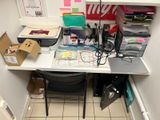 a desk with a chair and a computer on it