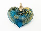 a blue and gold heart shaped pendant on a white surface