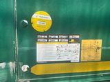 a green box with a yellow sticker on the side of it