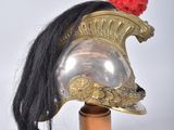 a helmet with a red pom on top of it