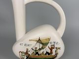 a white pitcher with a picture of a boat on it