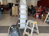 a picture of a room with a ladder and a vacuum in it
