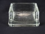 a clear glass container with a small square inside of it