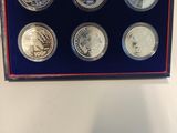 a box of six coins with a picture of a man on it