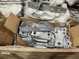 a box full of assorted metal parts in a pile