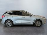 a silver suv parked in a room with a white wall