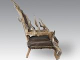 an image of a wooden chair with antlers on it