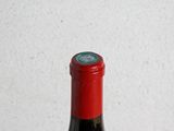 a bottle of wine sitting on a wooden table