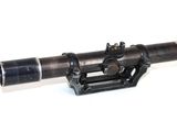 a small telescope that is sitting on a white surface