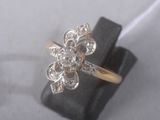 an image of a diamond flower ring on a ring stand