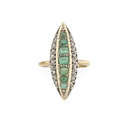 a close up of a gold ring with emeralds and diamonds