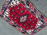 rug on the floor is red and blue with a pattern