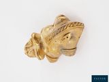 an antique gold figurine of a woman with a hat on her head