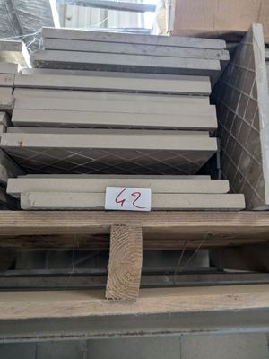 several stacks of wooden planks stacked on top of a pallet