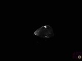 a close up of a diamond in the dark with a black background
