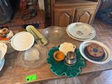 many plates and bowls on a table with a green flower