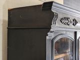a black cabinet with a mirror on top of it