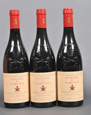 three bottles of red wine sitting on top of a table