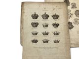 an old book with a bunch of crowns on top of it