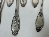 five spoons that are sitting on a table