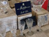 boxes of wine glasses and wine glasses are stacked on top of each other