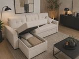 a couch with a pull out bed in the middle of a living room