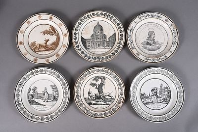 six plates with different designs on them sitting on a gray surface