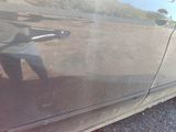 a reflection of a person on the side of a car