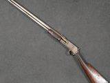 a rifle with a wooden barrel and a metal handle