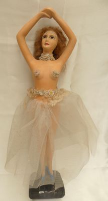 a figurine of a woman in a tutu skirt