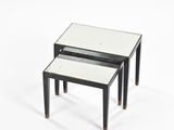 two black and white tables with mirrored tops on a white surface