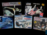 five star wars action figures on display on a black background
