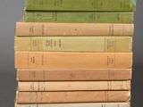 several books stacked on top of each other on a gray surface