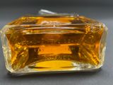an image of a bottle of perfume sitting on top of a table