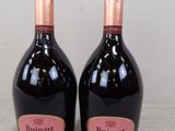 two bottles of wine sitting on top of a table next to each other