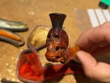 a person that is holding a pipe and a wooden object