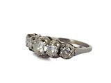 a close up of a three stone ring on a white background