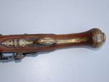 a wooden object with a metal handle on a white surface