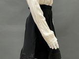 an image of a mannequin wearing a white shirt and black skirt