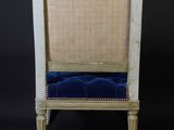 an image of a chair with a blue cushion on a black background
