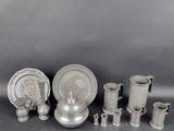 a group of silverware including a teapot, cups and saucer