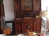 a room with a table, chairs, and a china cabinet in it