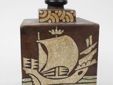 a small lamp that has a ship on top of it