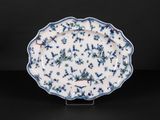 a blue and white plate with a floral design on it