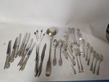 a lot of silver spoons and forks on the table