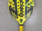 a yellow and black racquet with black dots on it