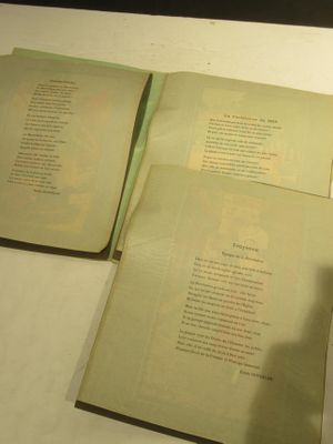 two open books sitting on a table next to each other